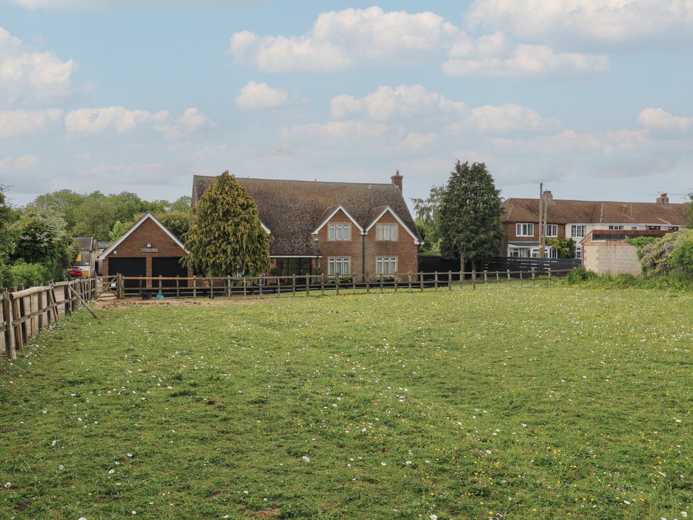 A house with a garage and fence in a field at Denmark House in Chatham, Kent
