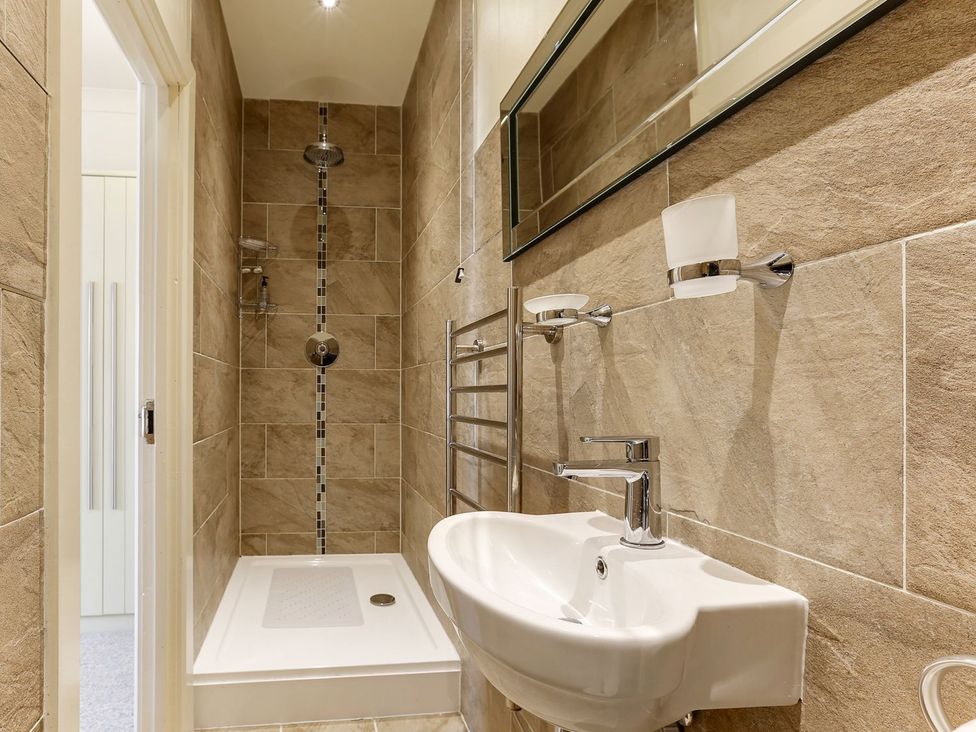 A bathroom with a shower and sink at Poppyfields Stable in Redruth