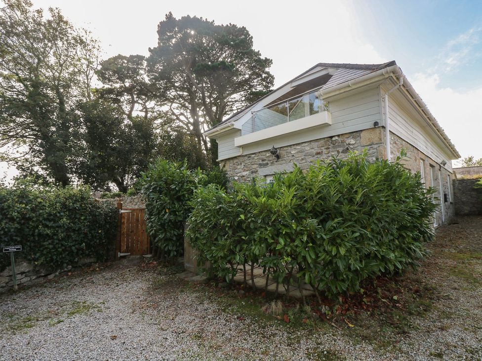 A house with greenery and a gravel area at Poppyfields Stable in Redruth