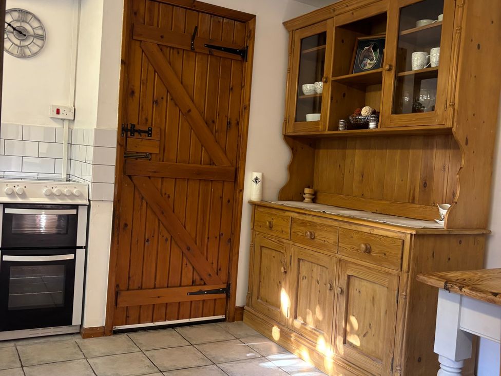 A kitchen with cabinets and an oven at 2 Bed Barn Barroway Drove near Downham Market