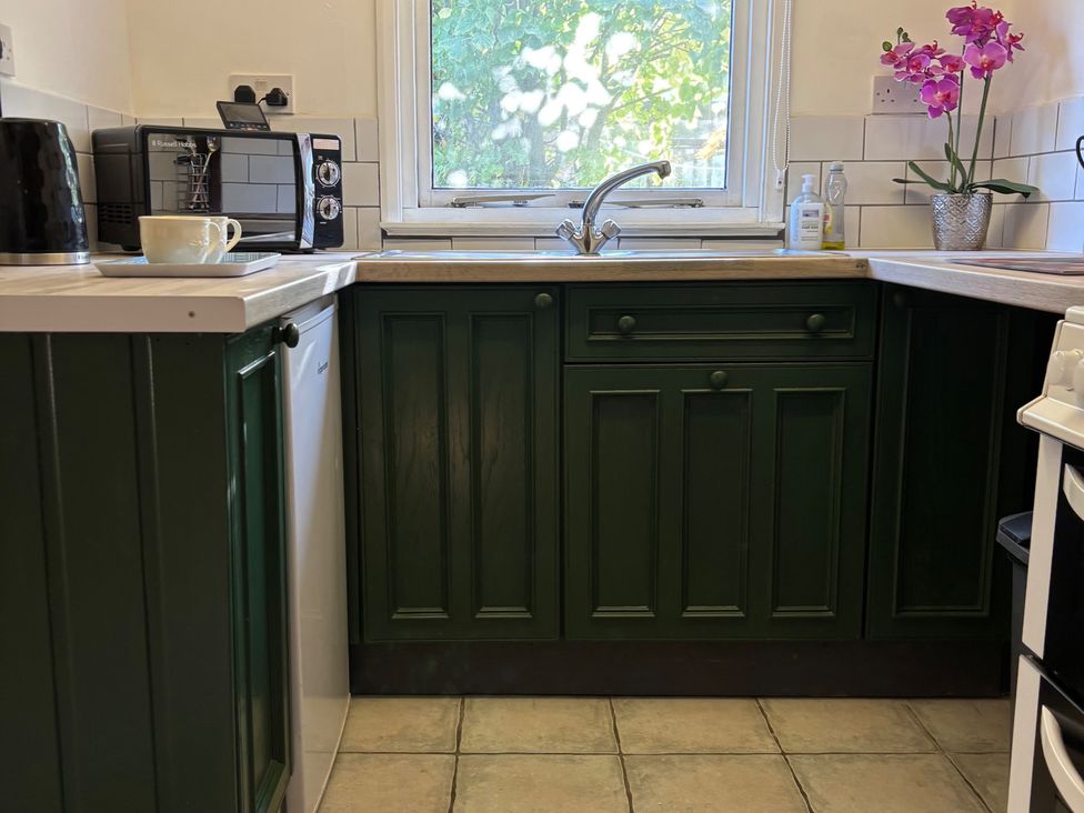 A kitchen with cabinets and a sink at 2 Bed Barn Barroway Drove near Downham Market
