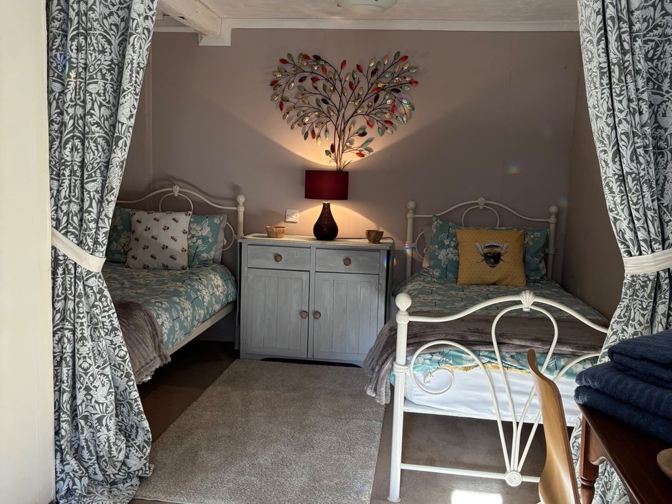 A bedroom with two beds and a cabinet at 2 Bed Barn in Barroway Drove near Downham Market