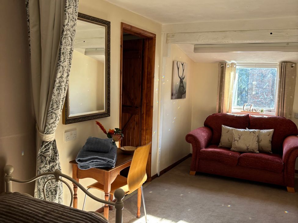 A living room with a sofa and table at 2 Bed Barn Barroway Drove near Downham Market