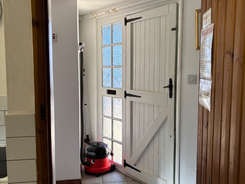 An entrance hall with a door and a vacuum cleaner at 2 Bed Barn Barroway Drove near Downham Market