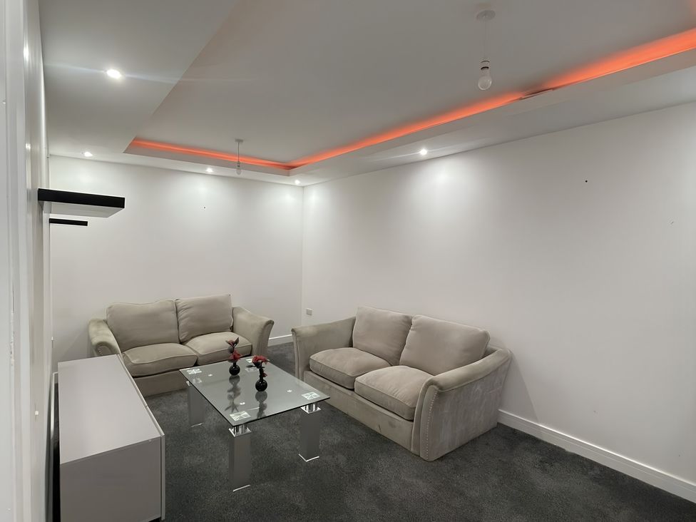 A living room with two sofas and a coffee table at Citrine Suite Stoke-on-Trent