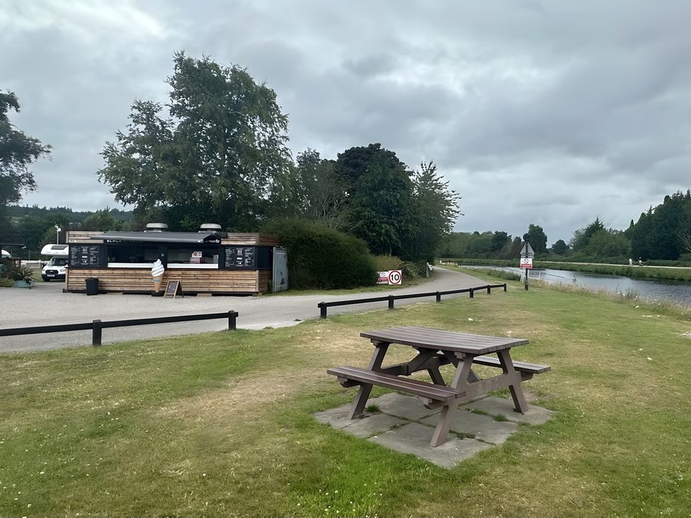 A food truck and picnic table near a river at Inverness Lodge in Inverness