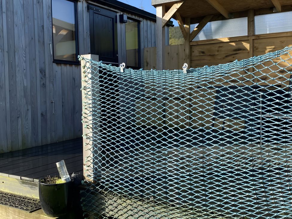 An outdoor area with wooden walls and a netting at Shepherds hut, Dumfries