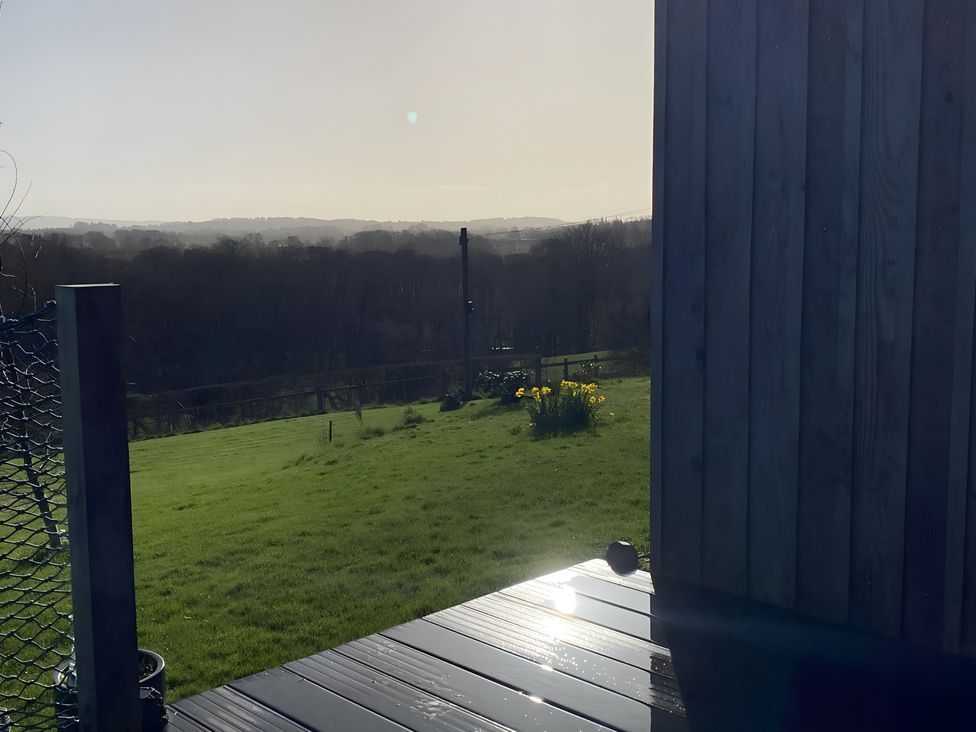 An outdoor area with grass and flowers at Shepherds hut Dumfries
