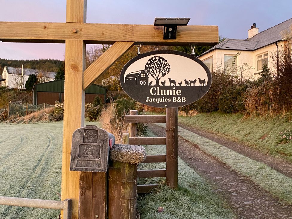 A sign for Clunie Jacquies B&B and a mailbox at Clunie in Dumfries
