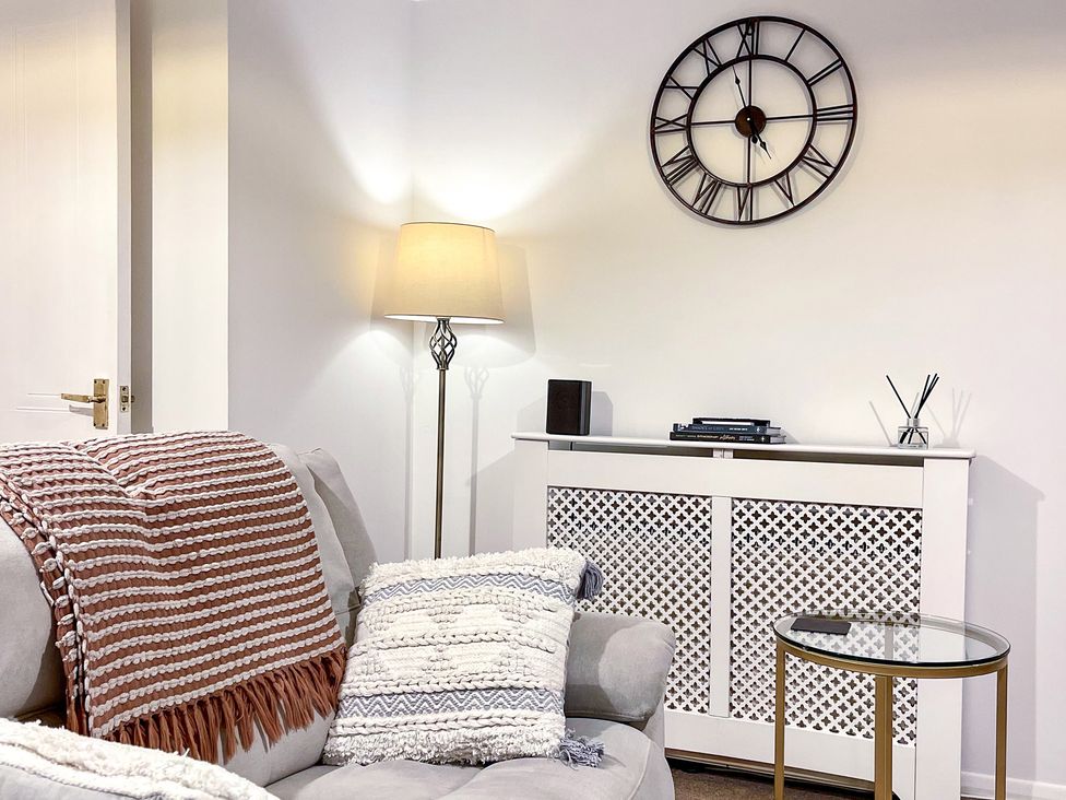 A living room with a sofa and lamp at 1-Bed Apt in Rochester, Kent