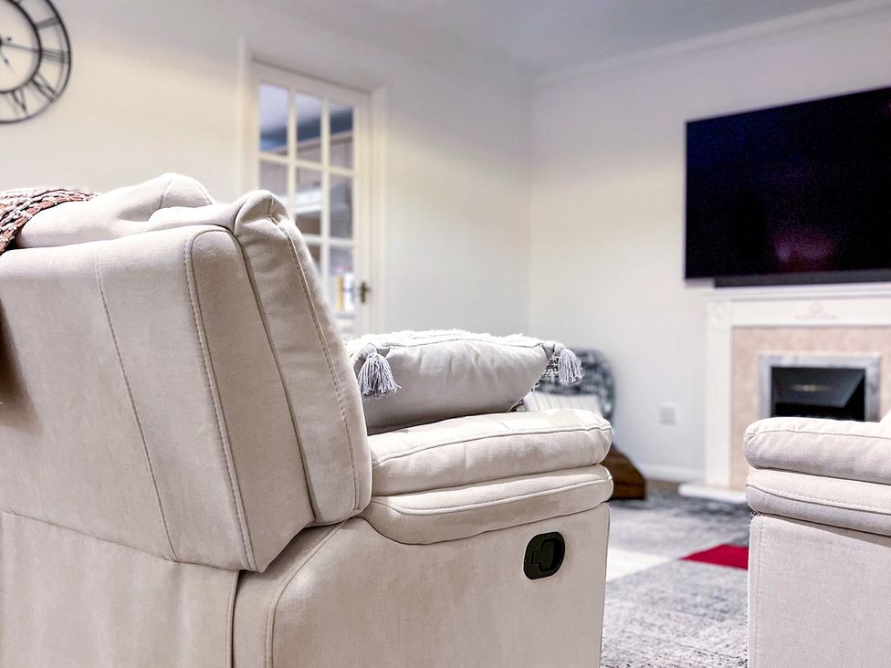 A living room with a sofa and television at 1-Bed Apt in Rochester, Kent