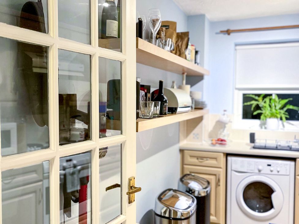 A kitchen with shelves and appliances at 1-Bed Apt in Rochester, Kent