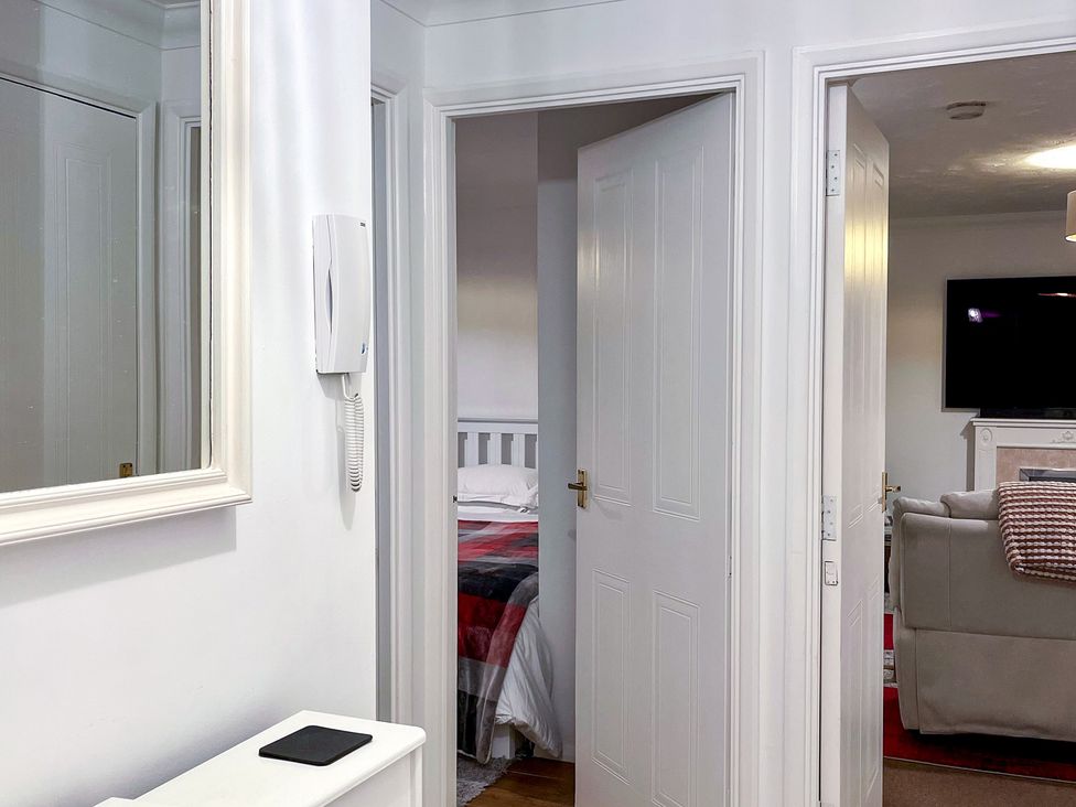A corridor with a door leading to a bedroom and a living room at 1-Bed Apt in Rochester, Kent