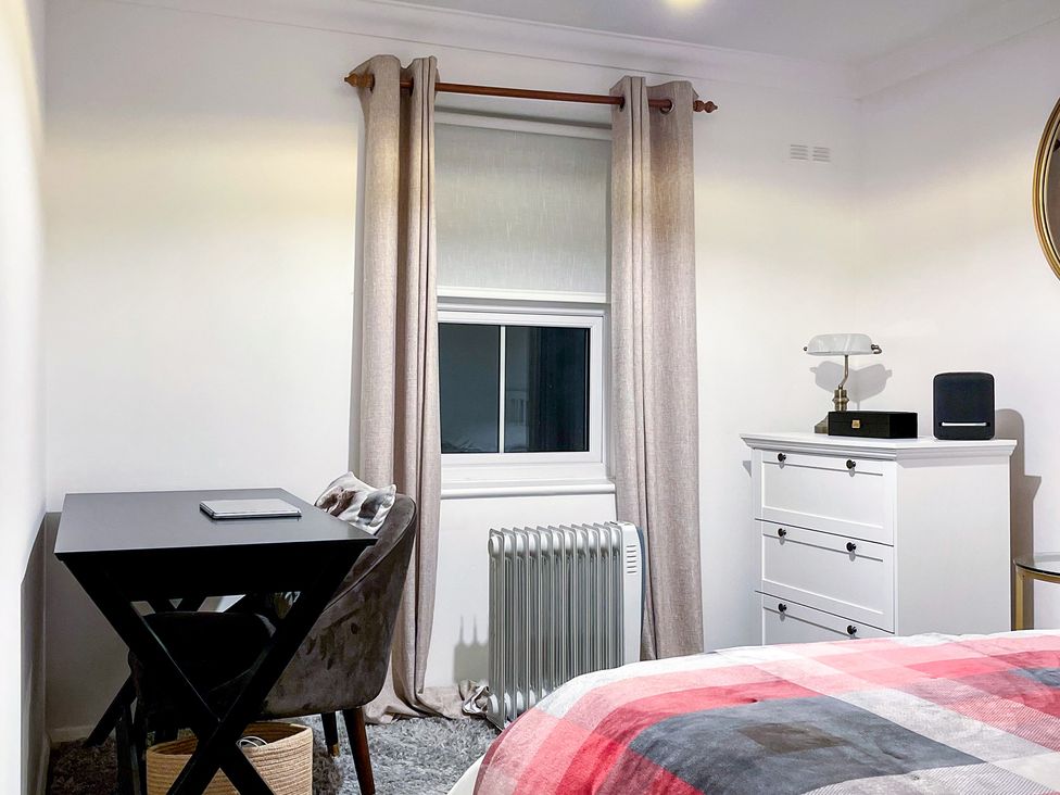 A bedroom with furniture including a desk and a dresser at 1-Bed Apt in Rochester, Kent