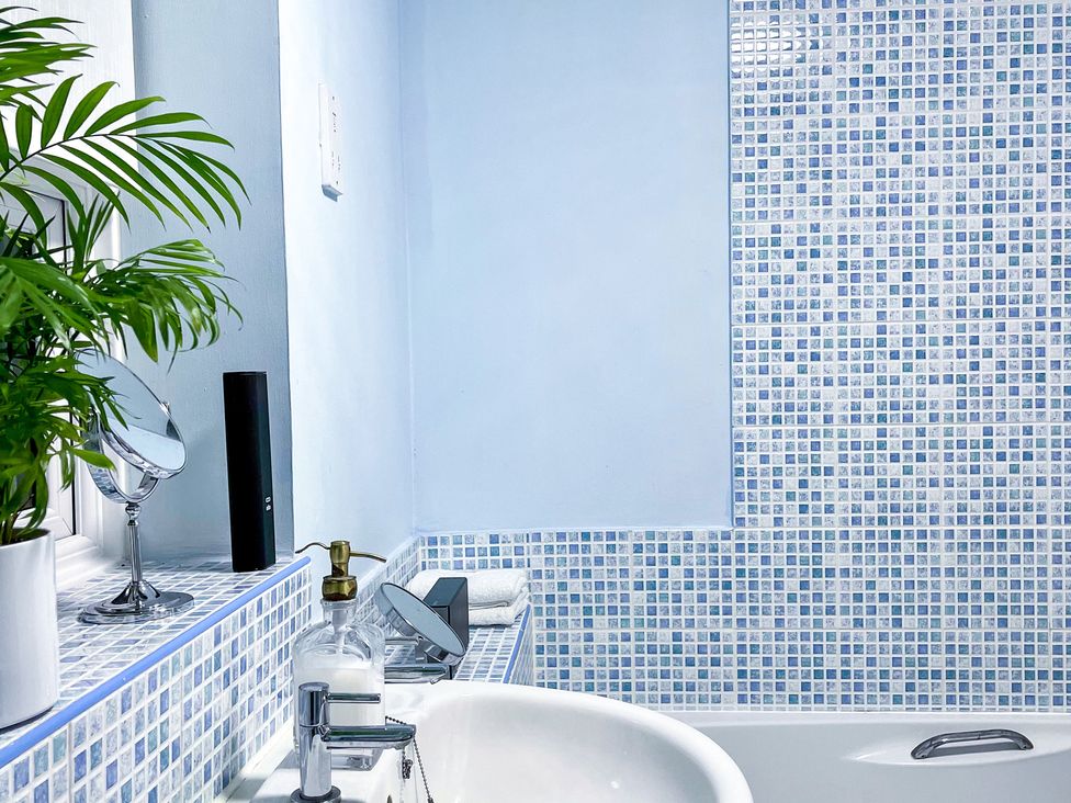 A bathroom with a bathtub and sink at 1-Bed Apt, Rochester, Kent