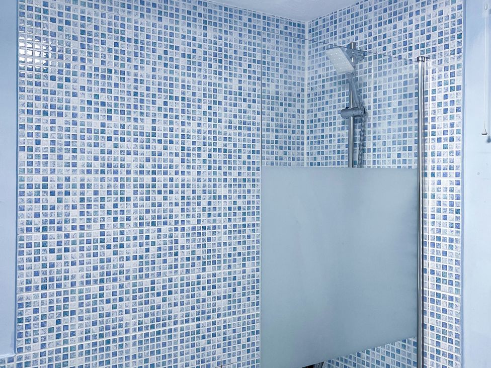 A shower with tiles and glass panel at 1-Bed Apt in Rochester, Kent