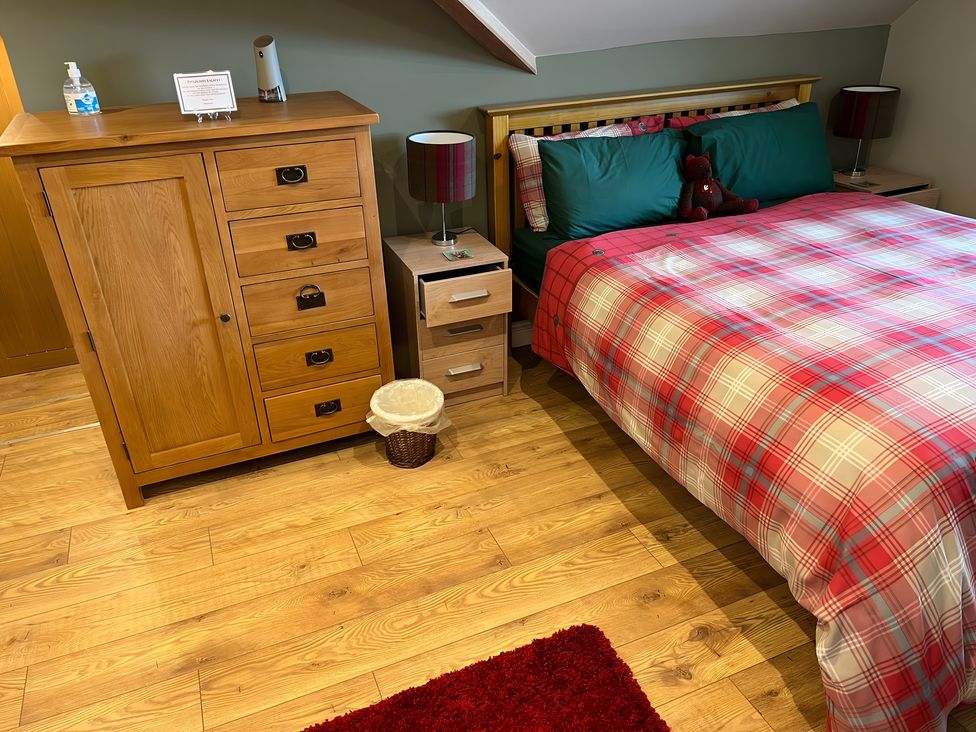 A bedroom with a bed and furniture at 1 Bed Studio in Pitlochry
