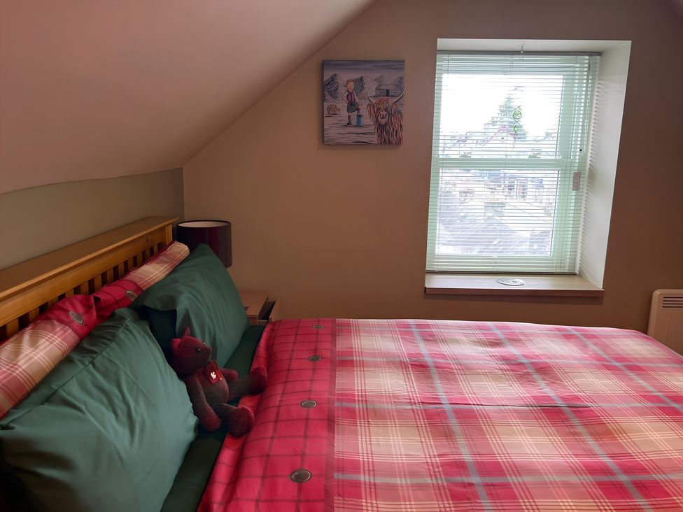 A bedroom with a bed and a window at 1 Bed Studio Pitlochry