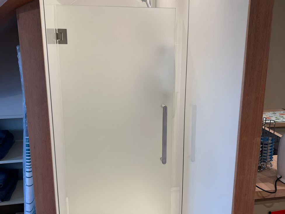 A glass shower in a bathroom at 1 Bed Studio in Pitlochry