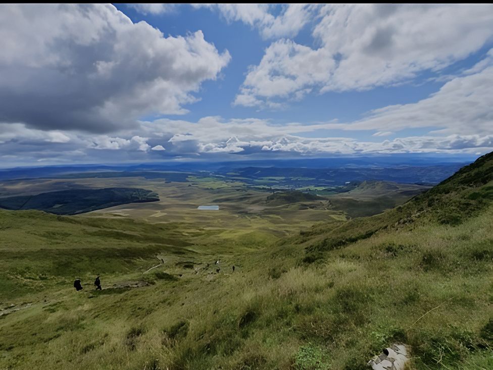 A landscape with hikers on a path at 1 Bed Studio in Pitlochry