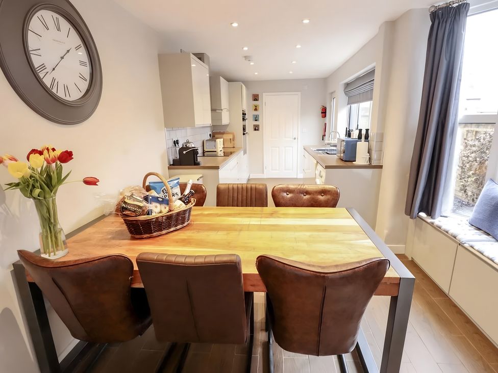 A dining room with a table and chairs at Love Lane Villa in Lincoln