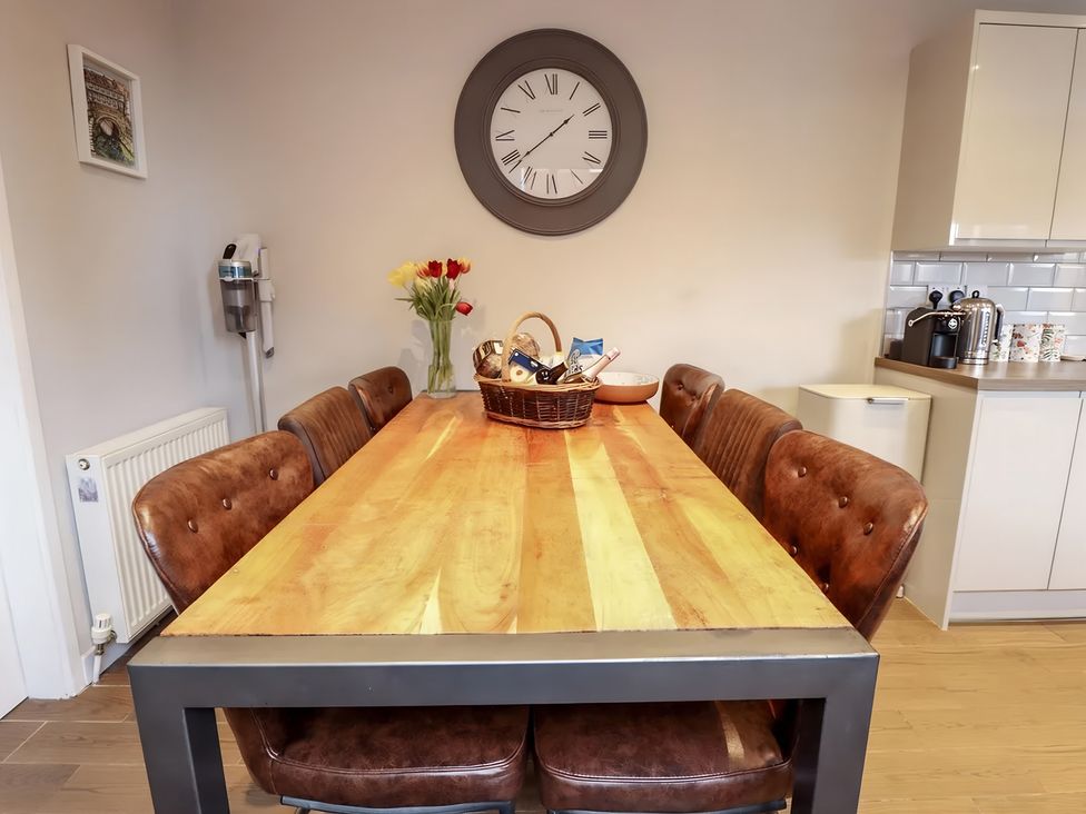 A dining room with a table and chairs at Love Lane Villa in Lincoln