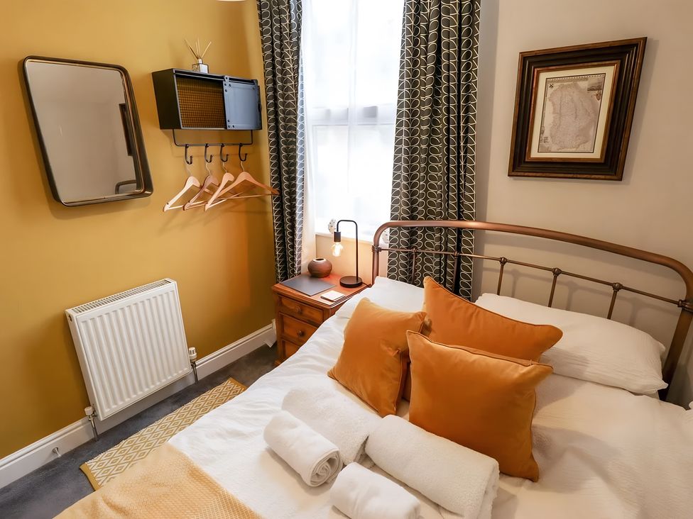 A bedroom with a bed and decorative pillows at Love Lane Villa in Lincoln