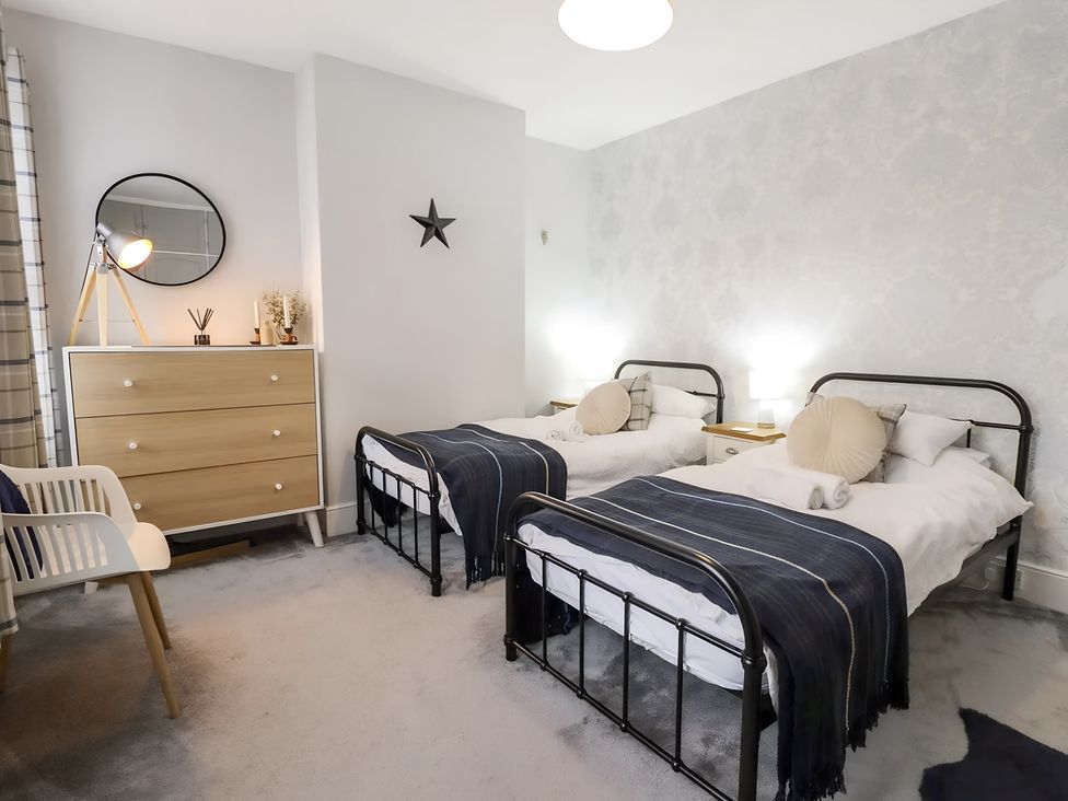 A bedroom with two beds and a dresser at Love Lane Villa in Lincoln