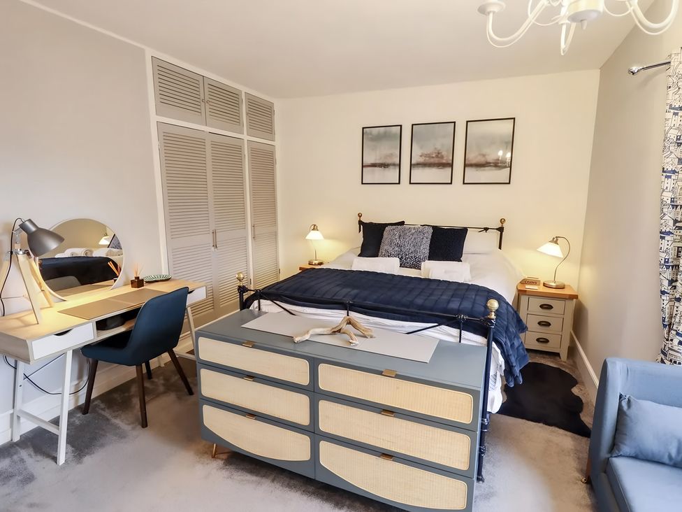A bedroom with a bed and study area at Love Lane Villa in Lincoln