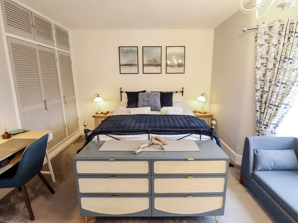 A bedroom with a bed and dresser at Love Lane Villa in Lincoln