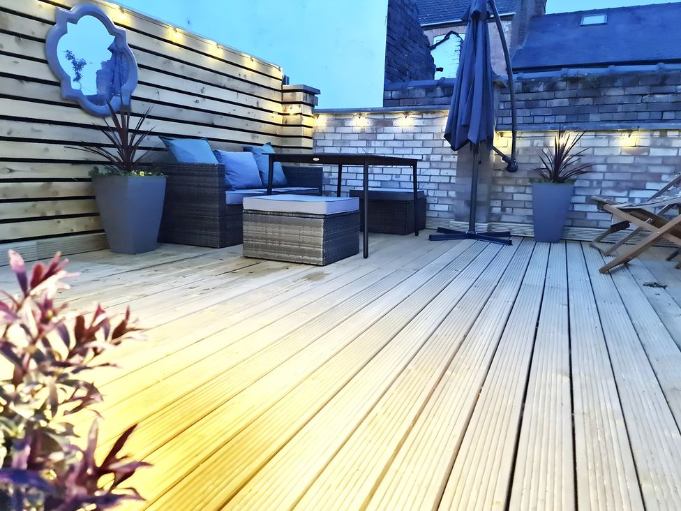 An outdoor area with seating and a table at Love Lane Villa in Lincoln