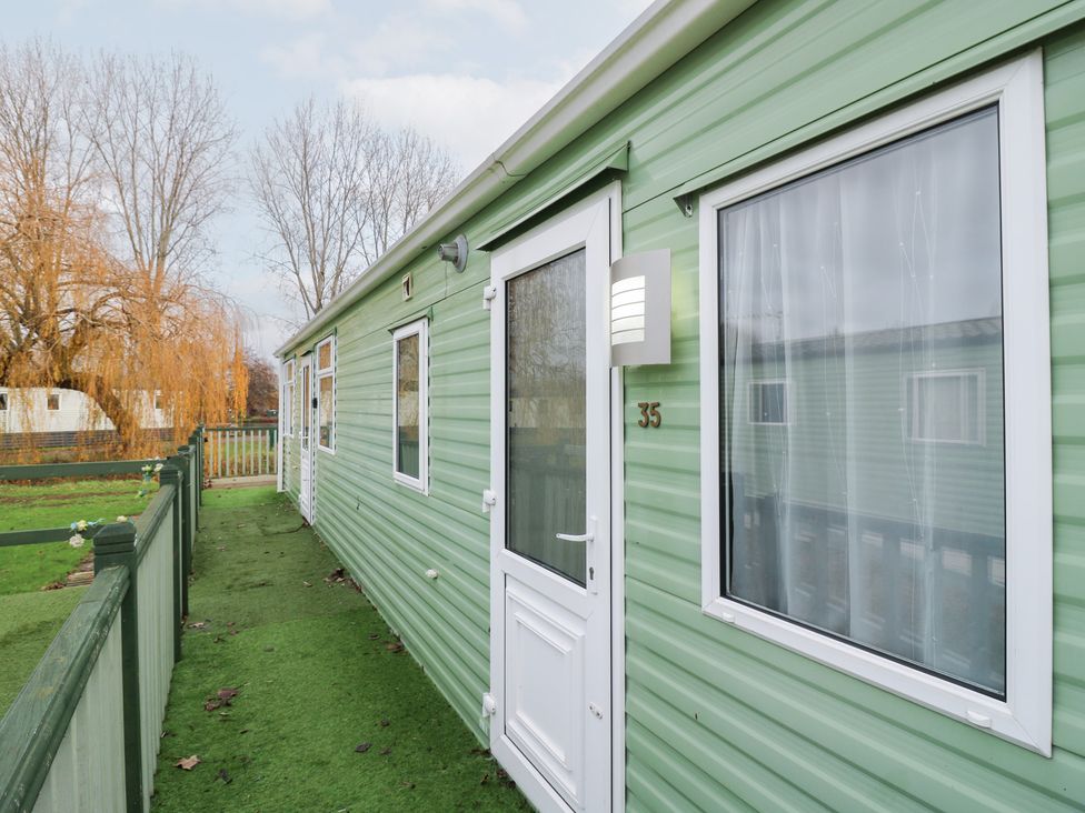 An outdoor area with a mobile home and grassy surroundings at No 35 MP Billing Aquadrome Holiday Park