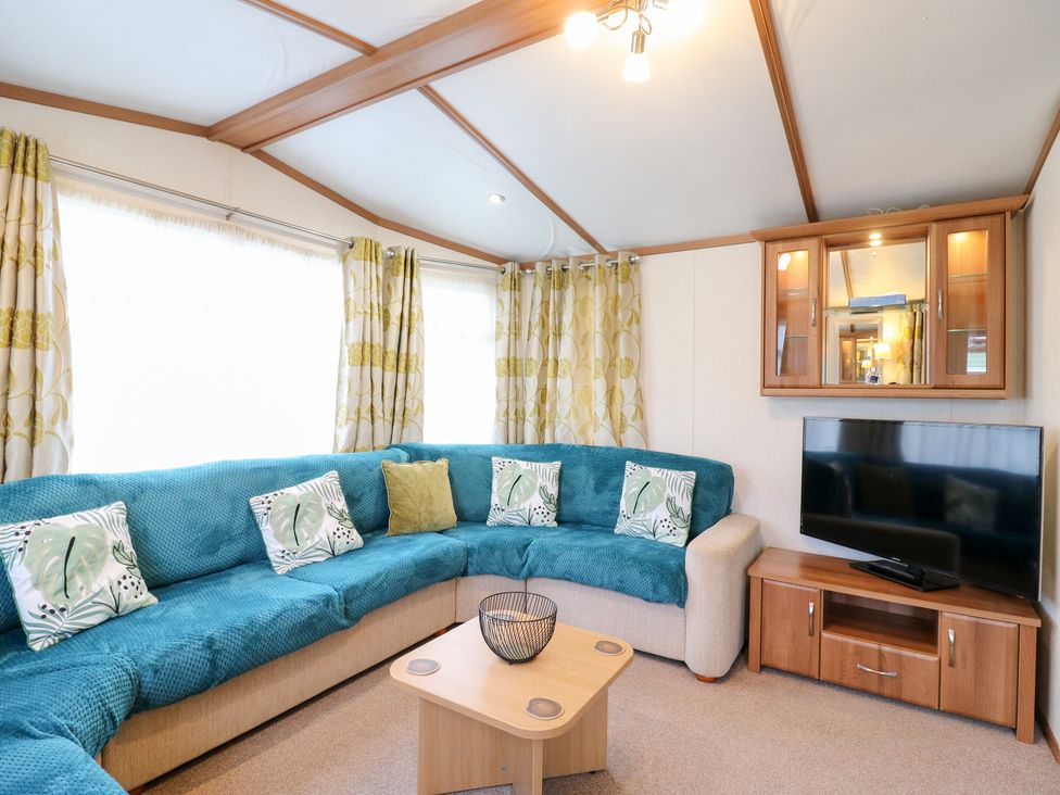 A living room with a sofa and TV at No 35 MP Billing Aquadrome Holiday Park
