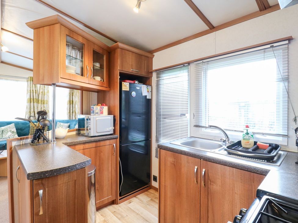 A kitchen with cabinets and appliances at No 35 MP Billing Aquadrome Holiday Park