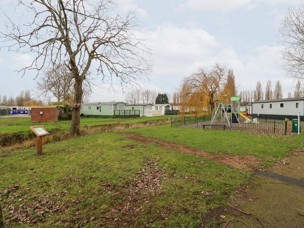 An outdoor area with a playground and caravans at No 35 MP Billing Aquadrome Holiday Park