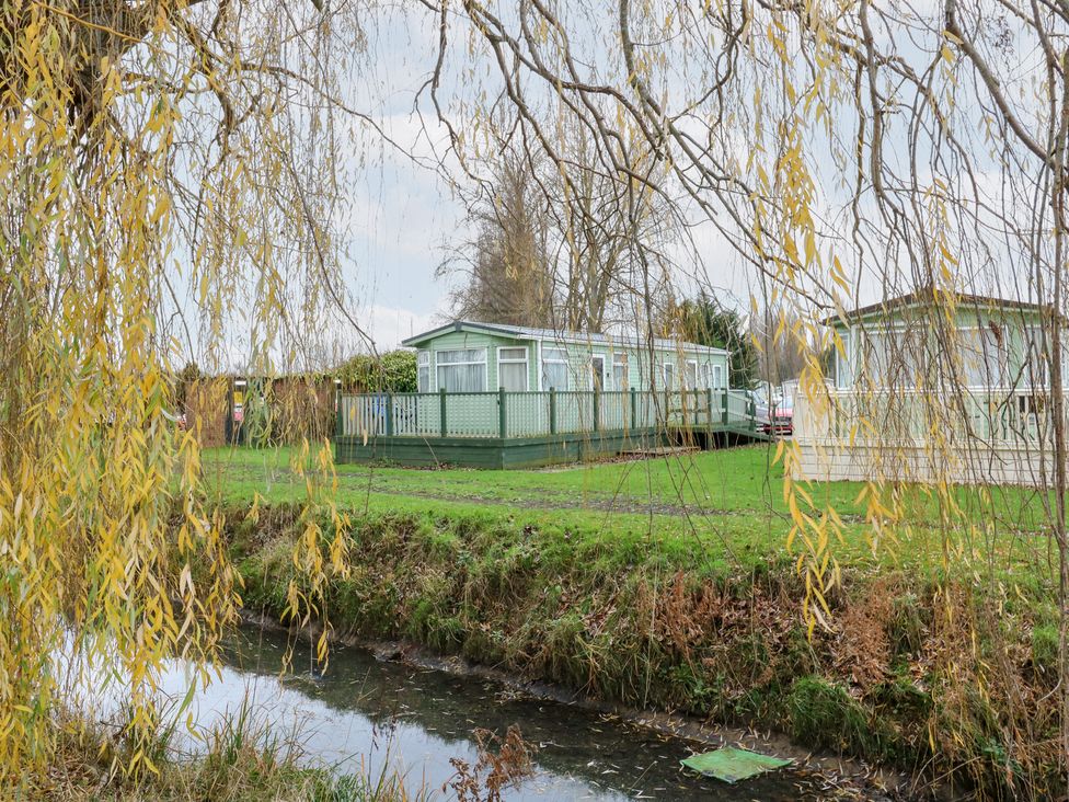 A view of caravans near a water body at No 35 MP Billing Aquadrome Holiday Park
