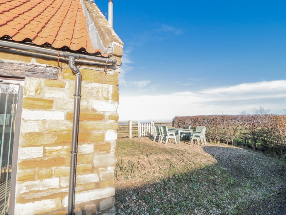 An outdoor area with a table and chairs at Millstone cottage in Whitby