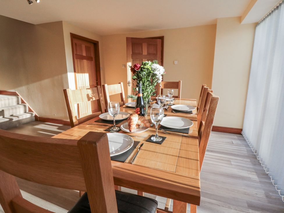 A dining room with a table and chairs at Millstone Cottage Sneaton Thorpe near Whitby
