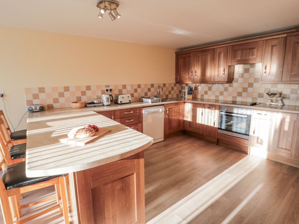 A kitchen with countertops and appliances at Millstone Cottage in Sneaton Thorpe near Whitby