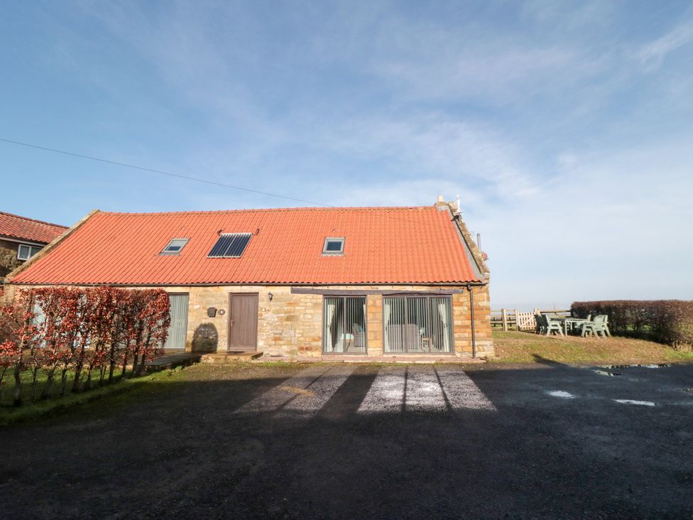 A house with windows and a door at Millstone Cottage Sneaton Thorpe near Whitby