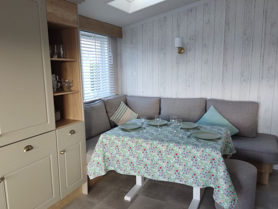 A dining area with a table set for meals at Harbour View in Poole