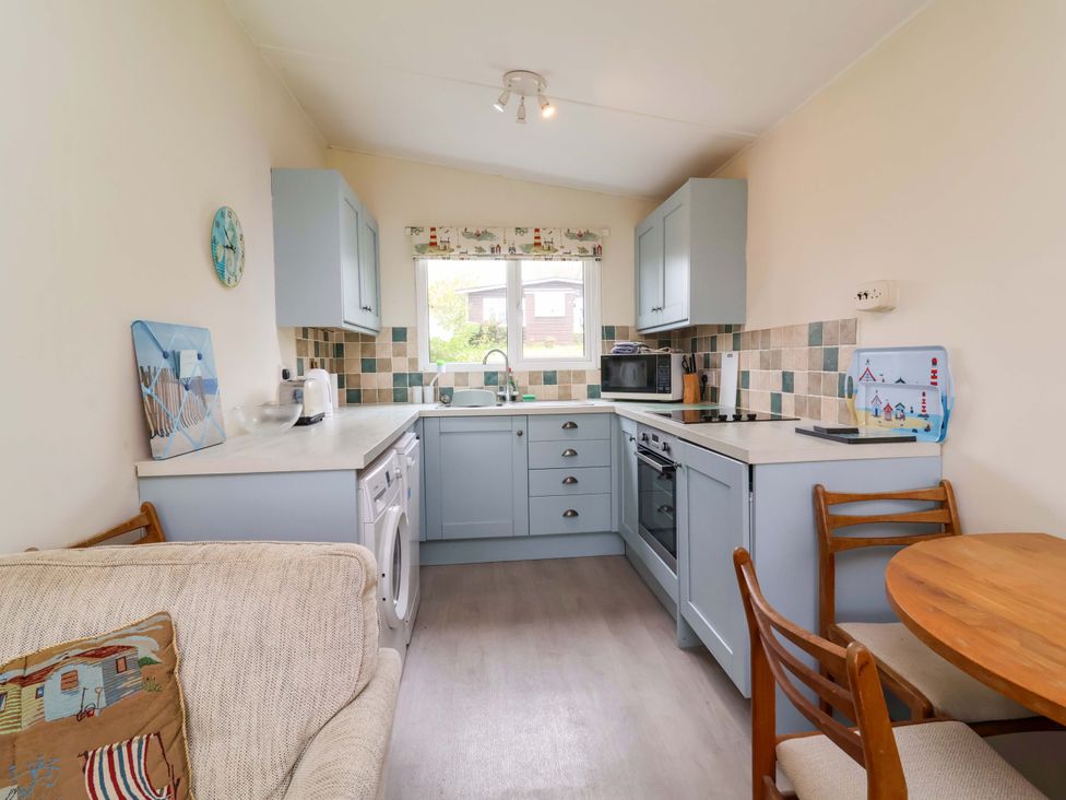A kitchen with cabinets and appliances at Sea Breeze near Morwenstow