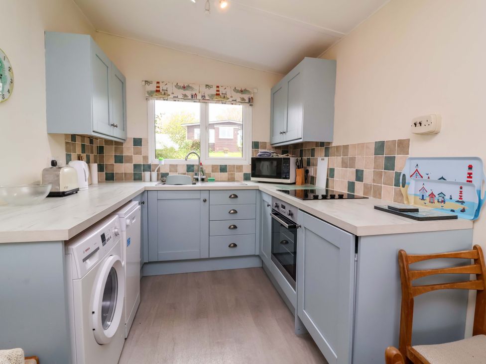 A kitchen with appliances and a countertop at Sea Breeze, Welcombe near Morwenstow