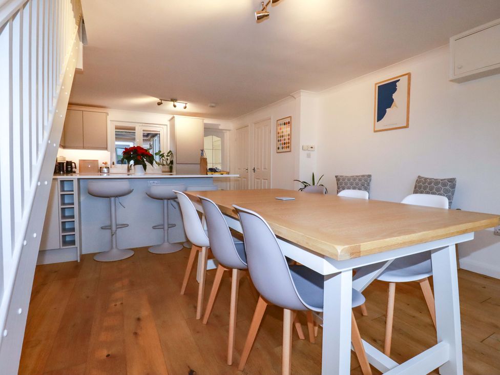 A dining room with a table and chairs at Poldreth in Truro