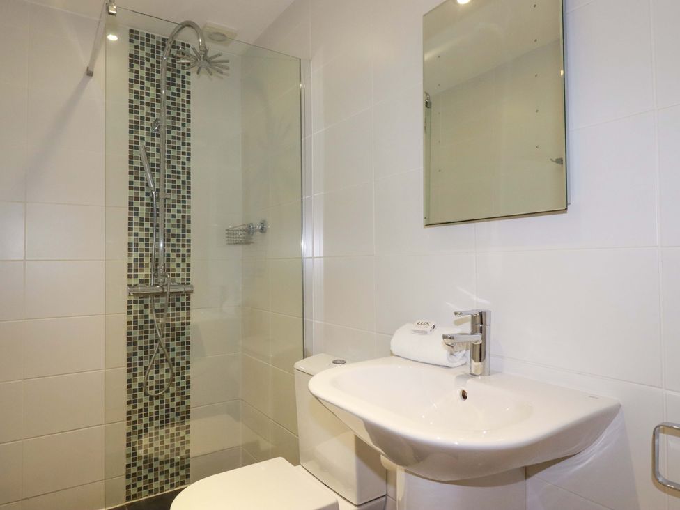A bathroom with shower, toilet and sink at Poldreth in Truro