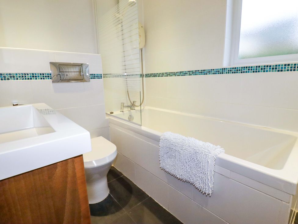 A bathroom with a bathtub and sink at Poldreth in Truro