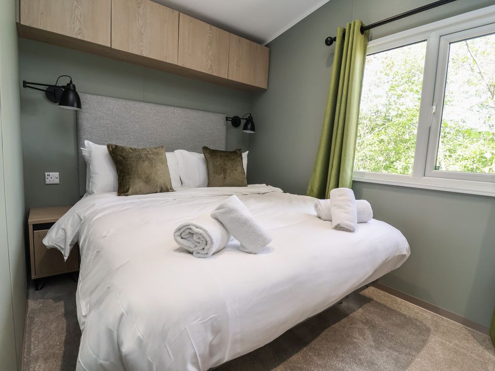A bedroom with a bed, pillows, and a window at No.6 - The Pines Delamere