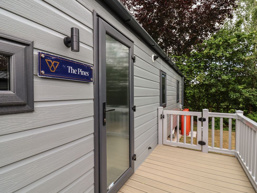 An entryway with a wooden deck and a sign at The Pines 3 Bedrooms Delamere