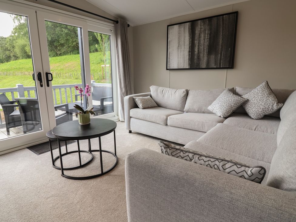 A living room with a sofa and coffee table at The Pines 3 Bedrooms in Delamere
