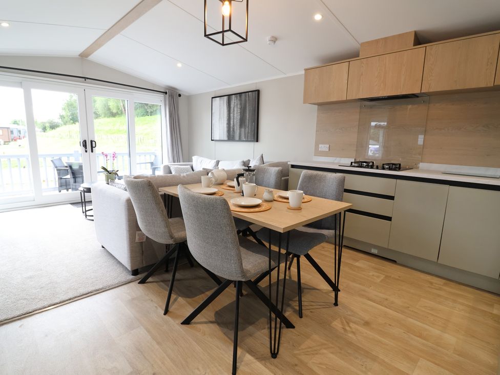 A dining area with a table and chairs at The Pines 3 Bedrooms in Delamere